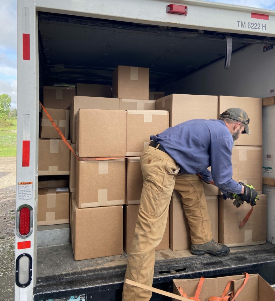 Man loading u-haul with boxes.